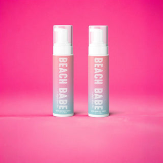 Self tanning Beach Babe bronzing mousse products on a pink background