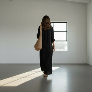 Black maxi shirt dress with collared neckline and relaxed silhouette walking view