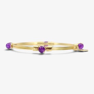 Bourbon and Boweties Morgan Bangle in gold wire with clear purple bead accents on white background