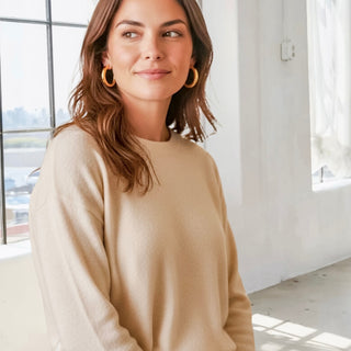 Model wearing bright gold medium size hoo hoops in a lifestyle setting