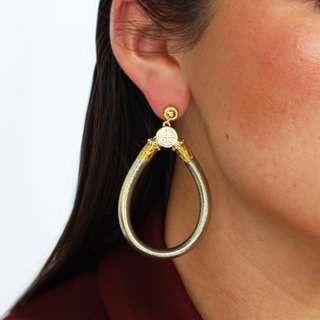 BudhaGirl Etoile All Weather Earrings worn on model, muted metallic gold teardrop statement earrings, lifestyle view showing size and fit on ear