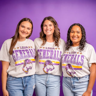 Three women wearing LSUA Generals t-shirts against a purple background
