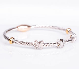 Two tone Cable X bracelet with silver cable, gold closure , X pave crystals and gold accents.