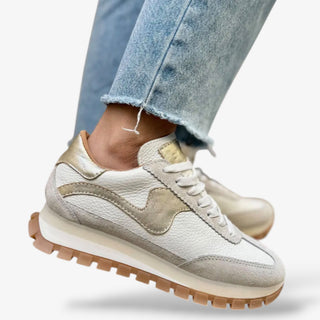 white leather retro sneaker with metallic gold accents and gum sole styled with cropped wide leg denim