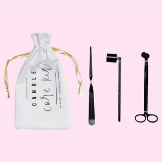 candle care kit black wick trimmer snuffer and dipper with white pouch pink background flat lay view