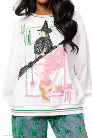 Model wearing Licensed Elphaba & Glinda Card Sweatshirt with sequin Wicked character design