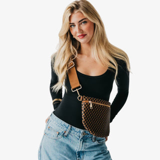 Woman wearing a Pretty Simple Westlyn Woven Bum Bag in checkered coffee and black with gold zipper, styled with a black top and pinstripe blazer.