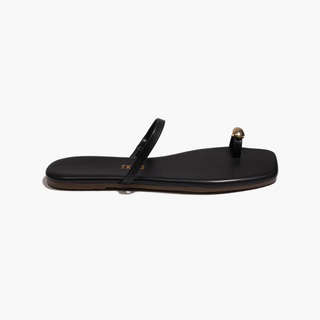 Black sandal with a gold toe accent on a white background