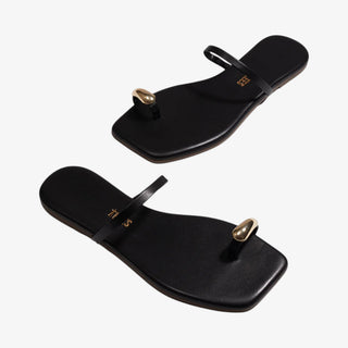 TKEES black toe ring sandal gold detail minimal flat sandal angled view