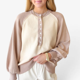 Colorblock Henley Sweater in cream and taupe close-up showing button neckline, contrast raglan sleeves and ribbed trim.
