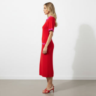  Red and hot pink short sleeve sweater midi dress showing its fitted silhouette and midi length from the side