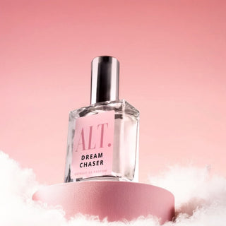 Perfume bottle labeled ALT Dream Chaser on a pink background