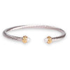 Silver and gold cable bracelet with pearl accents, classic and elegant design.