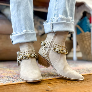 Diba True Paper Lily suede ankle boots worn with cuffed jeans, showing pointed toes and gold details, front view