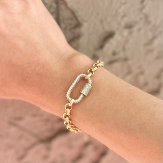 Gold bracelet on a wrist with a blurred background
