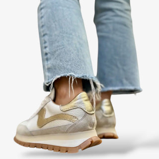 women’s white leather sneaker with gold detail and gum sole casual everyday sneaker with denim