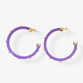 Purple hoop earrings with gold studs and gold post backs, approximately two inches in diameter, on a white background.