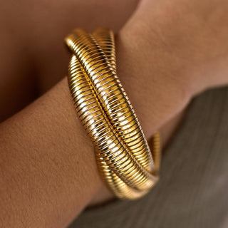 Chunky gold Anastasia bracelet with thick snake-like wrapped bands and stretch fit