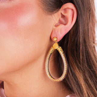 BudhaGirl Gold Bibi All Weather Earrings worn on ear with clear teardrop shape and gold accent beads side view