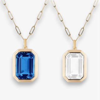 Two gold necklaces with gemstone pendants on a white background