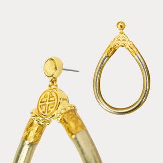 BudhaGirl Etoile All Weather Earrings with metallic gold teardrop design and gold-tone accents, close-up product view on white background