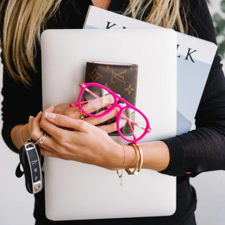 EyeJets Mykonos pink velvet blue light readers displayed with a laptop, wallet, and notebook for work and everyday use.