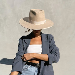 Beige wool felt rancher hat with flat wide brim and satin band.