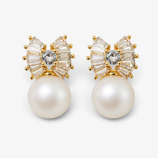 A pair of gold and pearl stud earrings featuring a fan-shaped cluster of clear baguette and round-cut stones with a central clear stone, hanging from large white pearls.