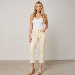 Women’s golden beige cropped straight leg jeans styled with a white tank and wedge sandals, full front view.