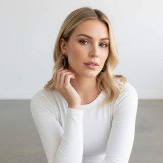 Model wearing Hoo Hoops tortoise hoop earrings medium size with chunky acrylic design and neutral everyday styling
