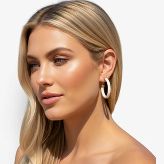 Model wearing Hoo Hoops white hoop earrings medium size with chunky acrylic design 