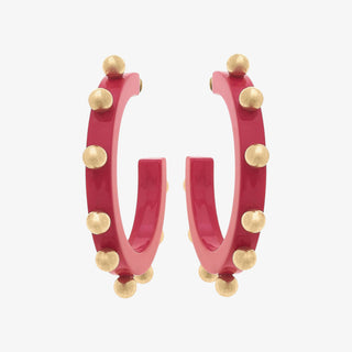 Fuchsia hoops earrings with small gold studded details on a white background