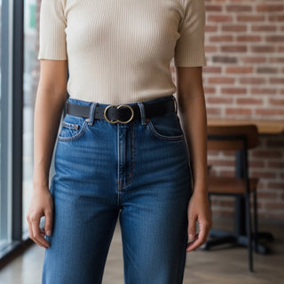 Model wearing a black leather belt with gold double chic ring design.