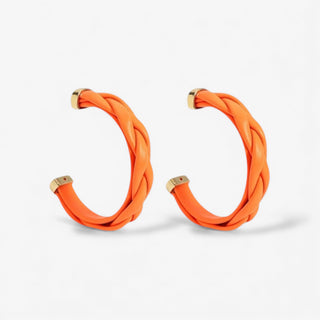 Large orange braided leather hoops with gold end cap detailing. 