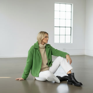 Green boucle cropped jacket side view with textured fabric and oversized collar styling detail