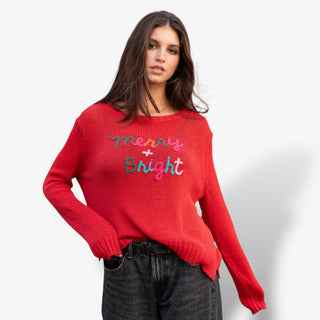 Woman wearing a red sweater with 'Merry Bright' text on a white background