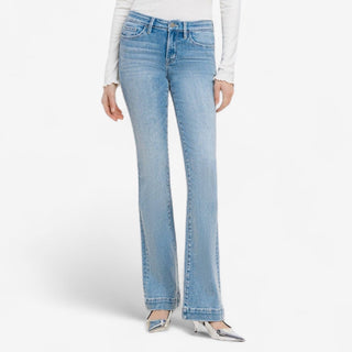 Light blue flared jeans worn by a person on a white background