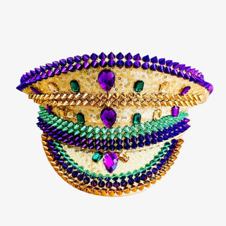 Conductor hat with gold, purple, and green beads, sequins, spikes and rhinestones on a white background.