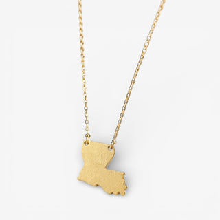 Gold necklace with a pendant shaped like the state of Louisiana on a white background