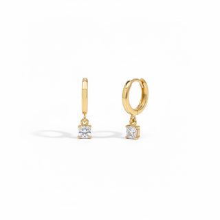 Gold hoop earrings with square gemstones on a white background