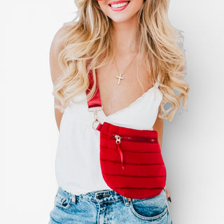 Woman wearing a red and white outfit with a visible zipper detail on a plain background
