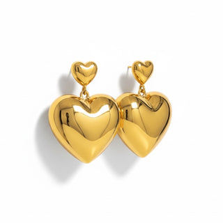 Gold heart-shaped earrings on a white background