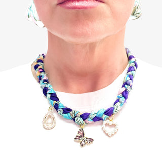 Colorful braided bracelet with charms on a white background