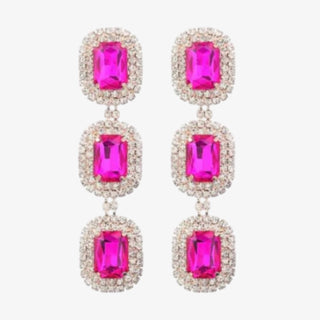 Pair of earrings with pink gemstones on a white background