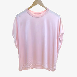 Pink t-shirt on a hanger against a white background