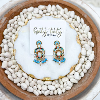 Fiesta Earrings with turquoise beads, red and black accents, and gold fringe displayed on Hoity Toity Boutique card