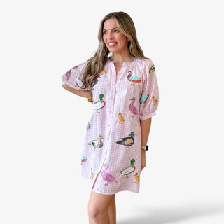 Queen of Sparkles pink gingham button front mini dress with colorful duck print, short puff sleeves, relaxed fit, and lightweight fabric for a fun spring and Easter outfit.