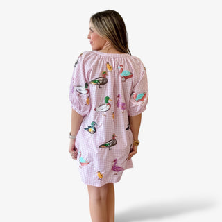 Queen of Sparkles pink gingham mini dress back view with colorful duck print, short puff sleeves, relaxed fit, and lightweight fabric for a fun spring and Easter outfit.