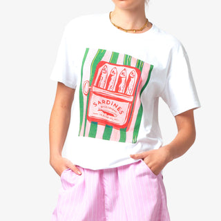 Person wearing a white t-shirt with a colorful graphic design on a plain background