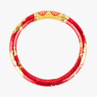 Red and gold bracelet on a white background